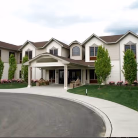 Front exterior view of Braemar at Medford with a covered entrance and curved driveway.