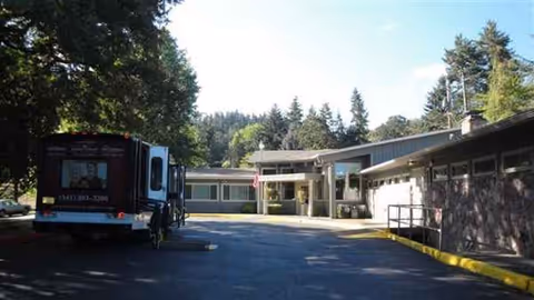 Exterior view of Hillside Heights Rehabilitation Center with a bus parked near the entrance.