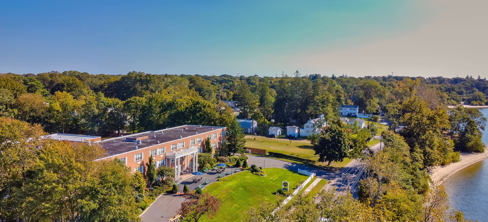 Aerial view of the Amber Court senior living facility surrounded by greenery and residential homes.