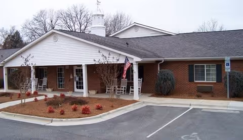 Front view of a single-story brick senior care home with a covered entrance.