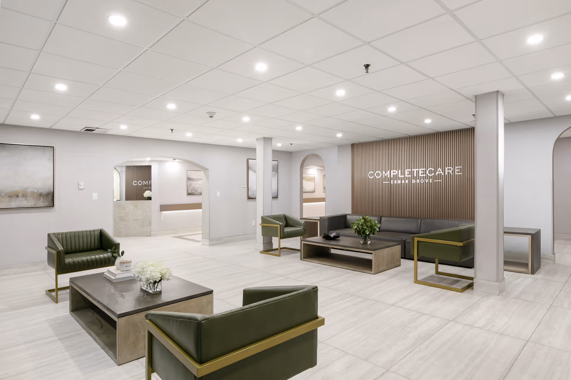 A modern and spacious lobby of Complete Care at Cedar Grove featuring green seating and decorative elements.