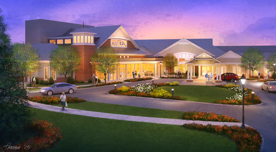 Evening exterior view of Fellowship Village with illuminated entrance and landscaped grounds.