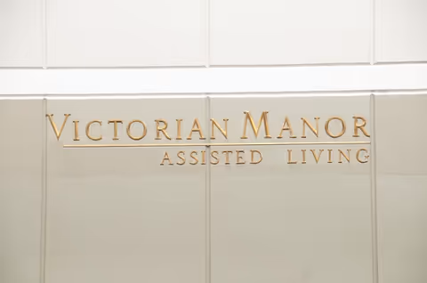 Front exterior wall displaying gold lettering for Victorian Manor Assisted Living.
