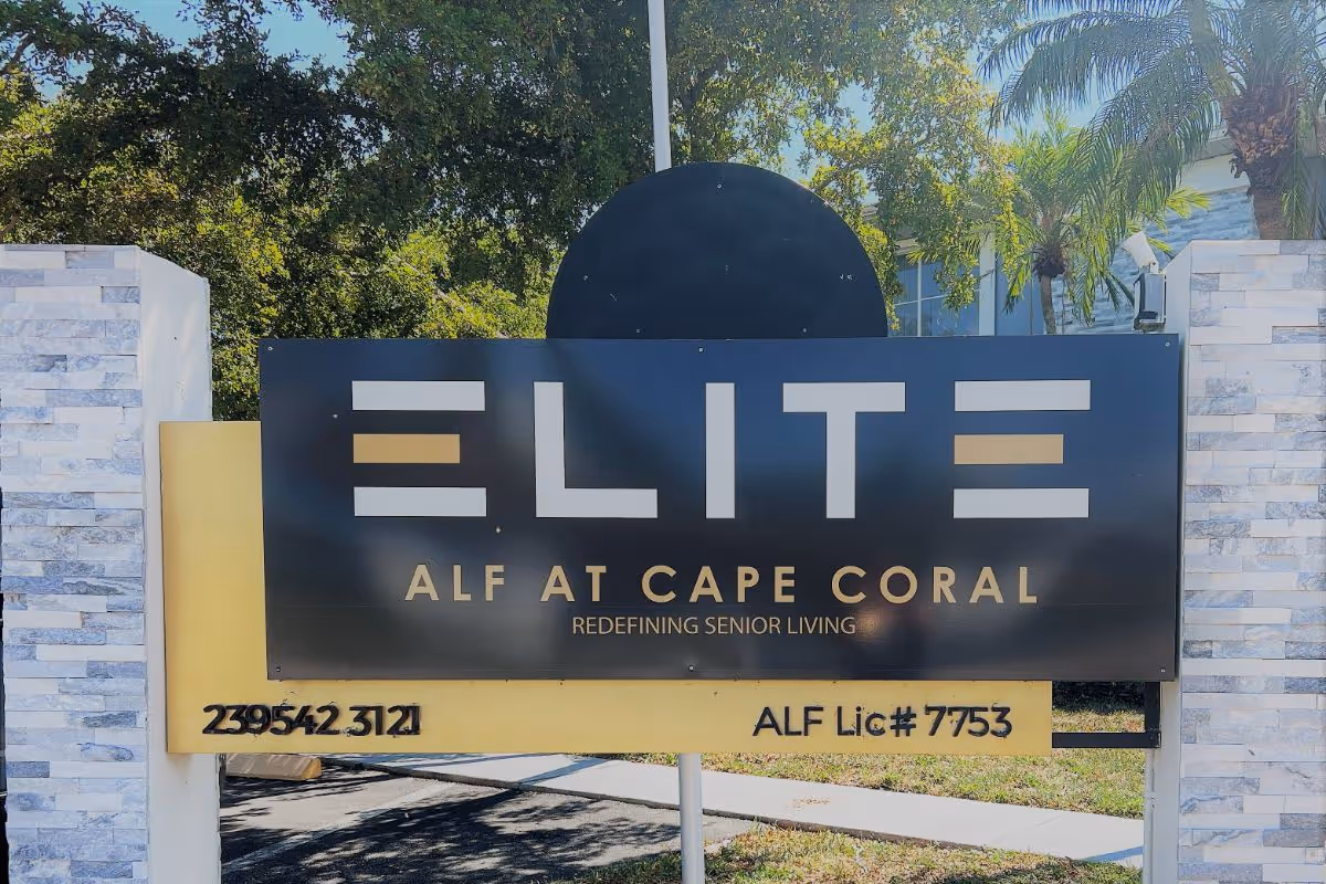 Front exterior sign for Elite ALF at Cape Coral, with stone pillars.