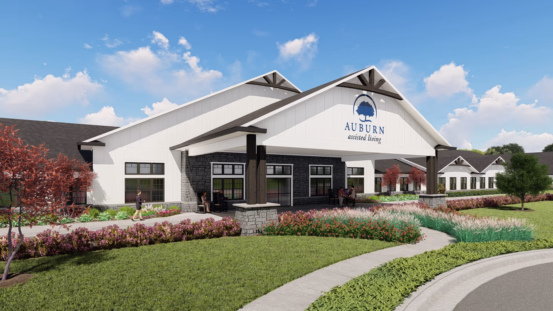 Front entrance of Auburn Assisted Living with a covered porte-cochere, landscaped lawn, and pathway under a blue sky.
