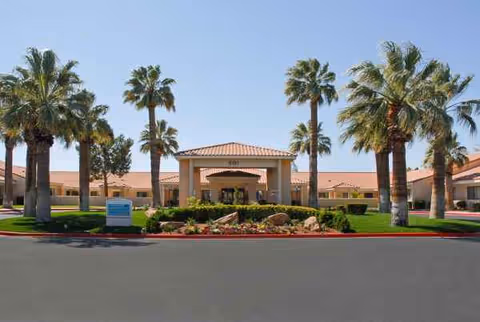 Front view of Life Care Center of Las Vegas with palm trees and landscaping.