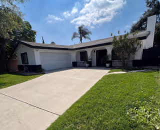 Single-story assisted living house with a driveway, garage, and front entrance.