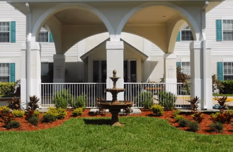 Front view of Fountain Crest Retirement Community with arched entrance and fountain.