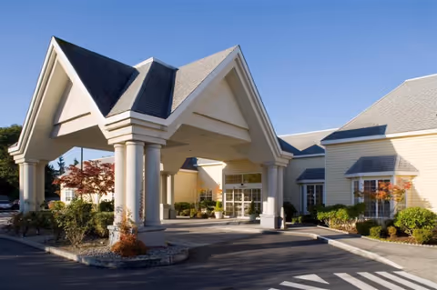 Exterior view of Richmond Beach Rehab facility with a covered entrance and columns