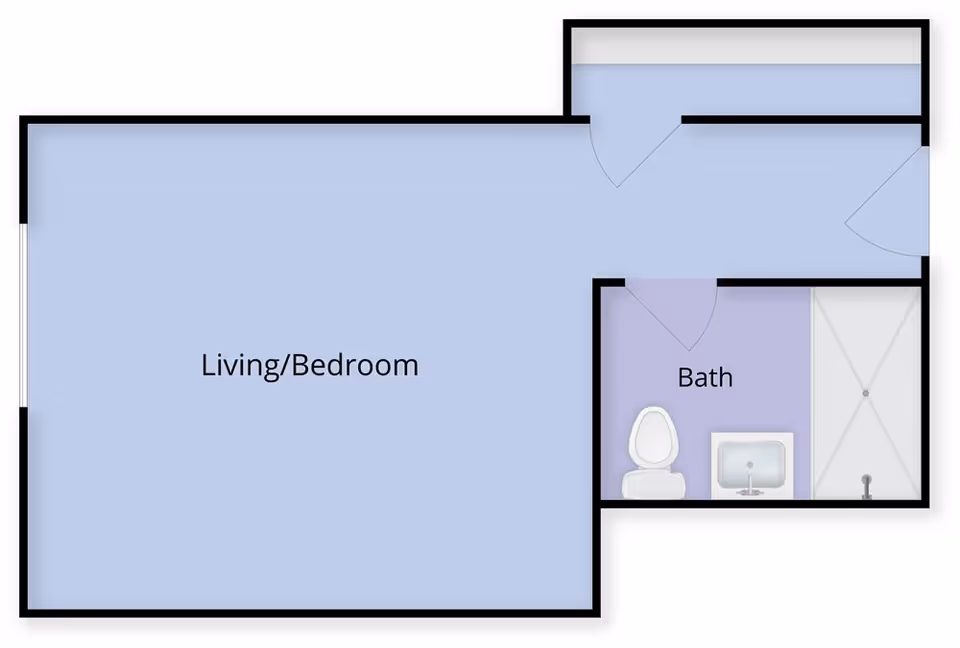 Floor plan of a studio layout showing a combined living/bedroom area and a separate bath with toilet, sink, and shower.