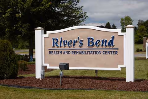 Exterior sign reads River's Bend Health and Rehabilitation Center with surrounding landscaping.