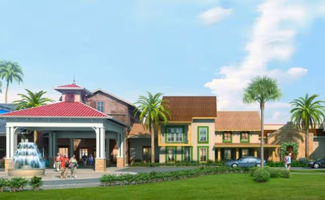 Exterior view of Symphony at Stuart entrance with palm trees, fountain, and parked cars.