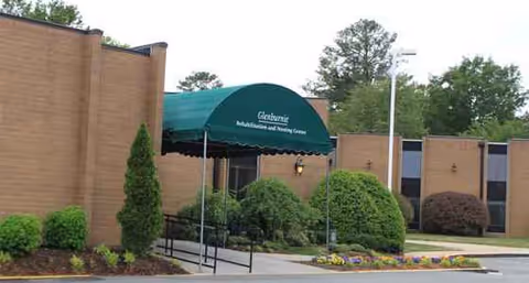 Exterior view of Glenburnie Rehabilitation and Nursing Center with green entrance awning and landscaping.