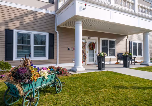 Exterior view of Windrose at Woburn entrance with a garden wagon and planters