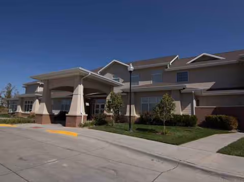 Exterior view of Ridgewood Senior Living facility with entrance canopy and landscaped grounds.