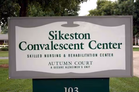 Outdoor sign on a grassy lawn reading Sikeston Convalescent Center