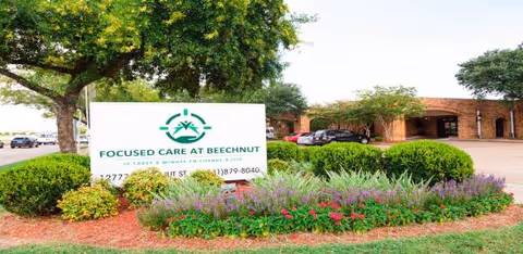Exterior view of Focused Care at Beechnut sign with a brick building and landscaping.