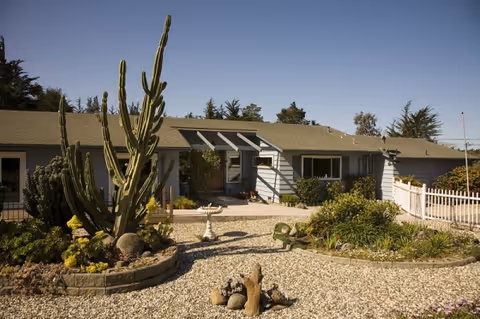 Front view of Carmel Villa, a single-story facility with desert landscaping.