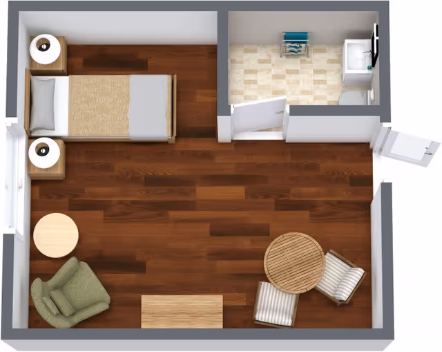 Top-down view of a small room layout with a single bed, two nightstands with lamps, a green armchair next to a round side table, a round dining table with two striped chairs, and an attached bathroom with a sink, toilet, and small storage shelf.