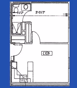 Architectural floor plan of a small apartment or studio unit labeled C105, showing a combined living and kitchen area, a bathroom with a toilet and sink, and a separate sleeping area with a bed.