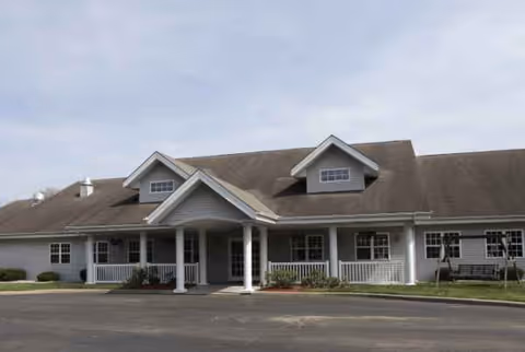 Bennett Place senior living facility building with a covered entrance and white railings.