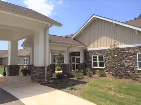 Front entrance of Rose Glen Manor with stone exterior, columns, and a covered walkway.