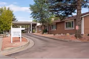 Exterior view of Colonial Columns LTC with brick building, drive-up entrance, and landscaped approach.