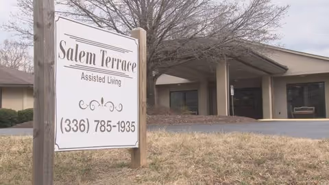Exterior view of a senior living facility entrance with a Salem Terrace sign
