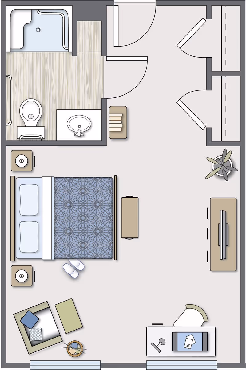Floor plan of a senior living facility room at Antebellum James Burgess showing a bedroom area with a bed, two nightstands, a chair with a side table, a desk with a chair, a TV on a stand, a small bench, a plant, and a bathroom with a shower, toilet, and sink.