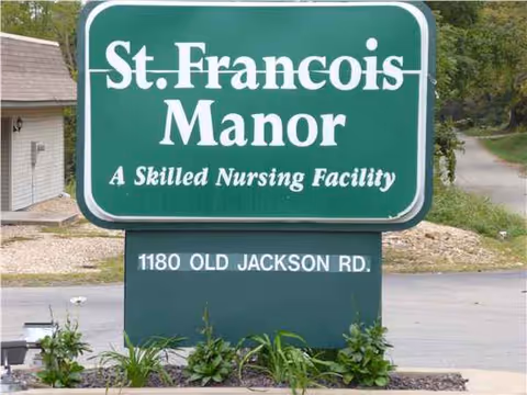 Green sign reads St Francois Manor, A Skilled Nursing Facility, with address at Old Jackson Rd.