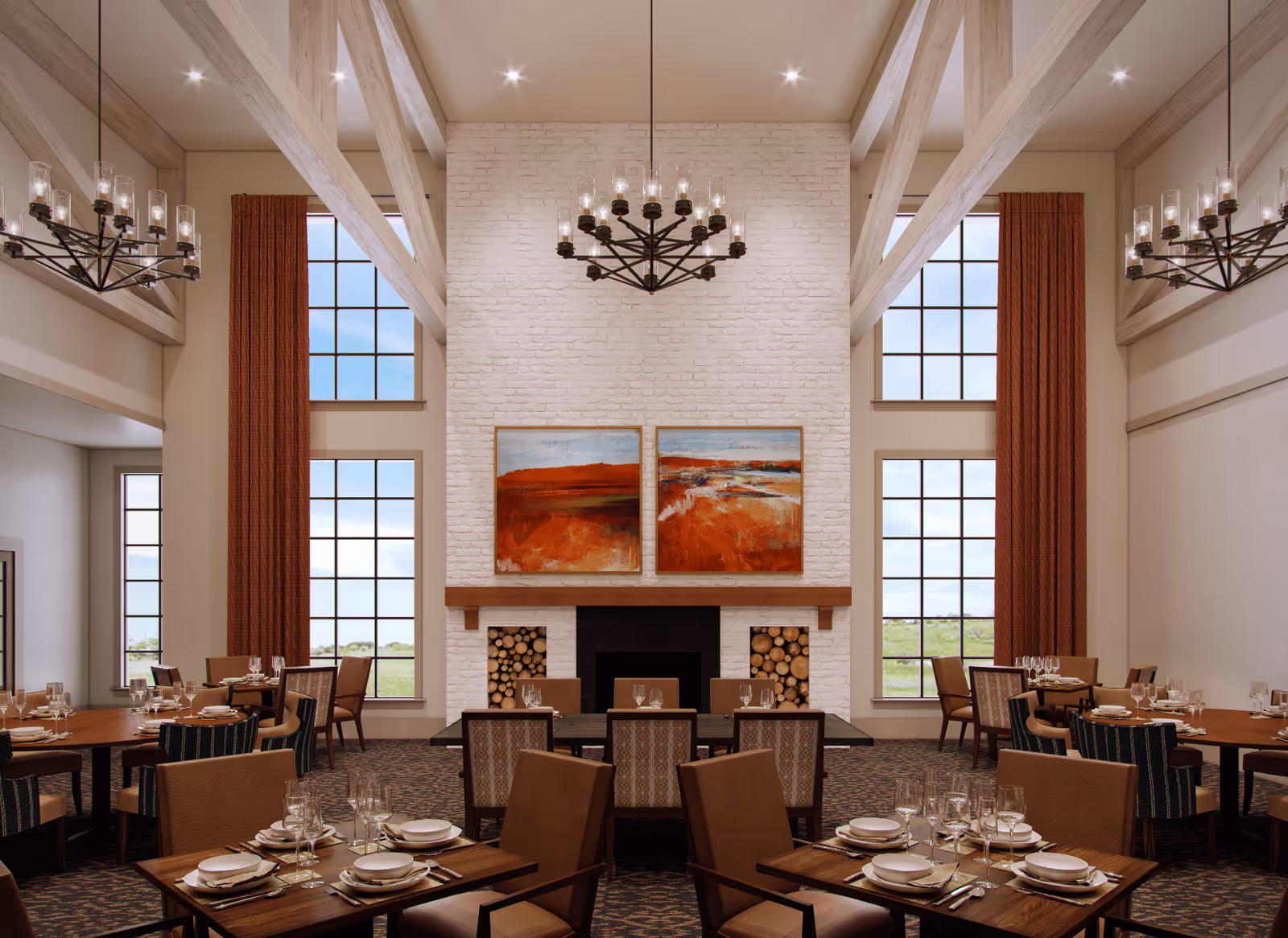 Spacious dining room with vaulted ceilings, large windows, chandeliers, a central brick fireplace, and multiple set dining tables.