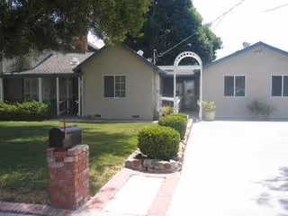 Front exterior view of Abigail Board & Care LLC facility with driveway and landscaping.