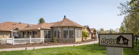 Conifer House senior living facility exterior with a tan, single story building and sign.