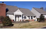 Front view of Patriots Colony at Williamsburg senior living facility building with brick and light siding.