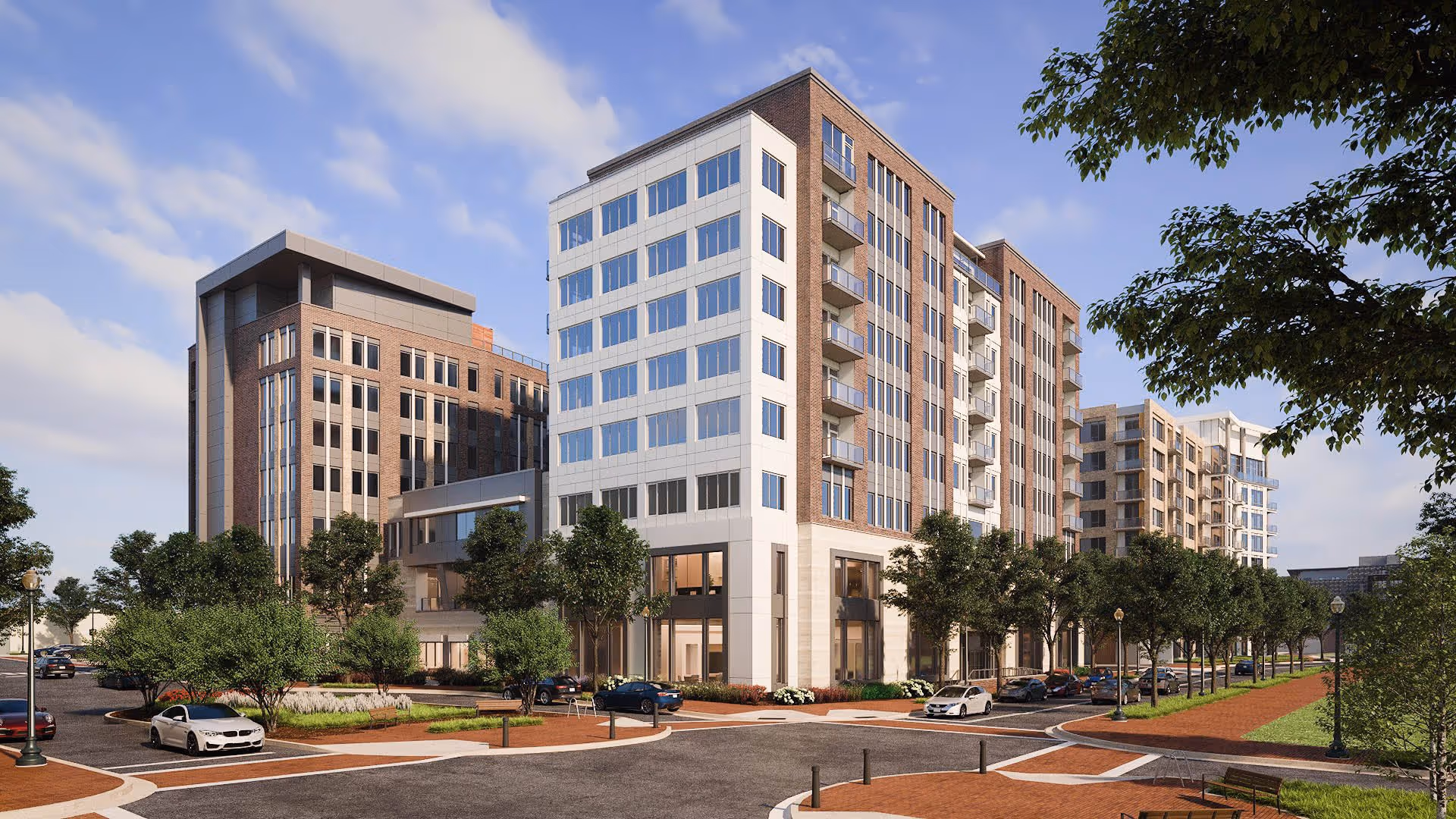 Exterior view of a modern multi-story senior living facility named The Landing Alexandria, featuring large windows, balconies, landscaped greenery, and parked cars along the street under a partly cloudy sky.