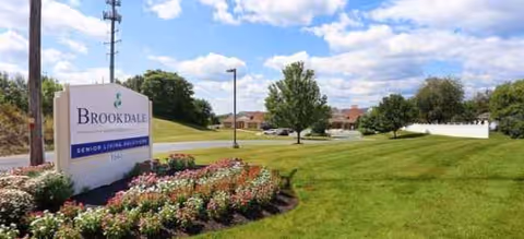 Exterior view of Brookdale Harrisburg with a landscaped lawn and entrance sign.