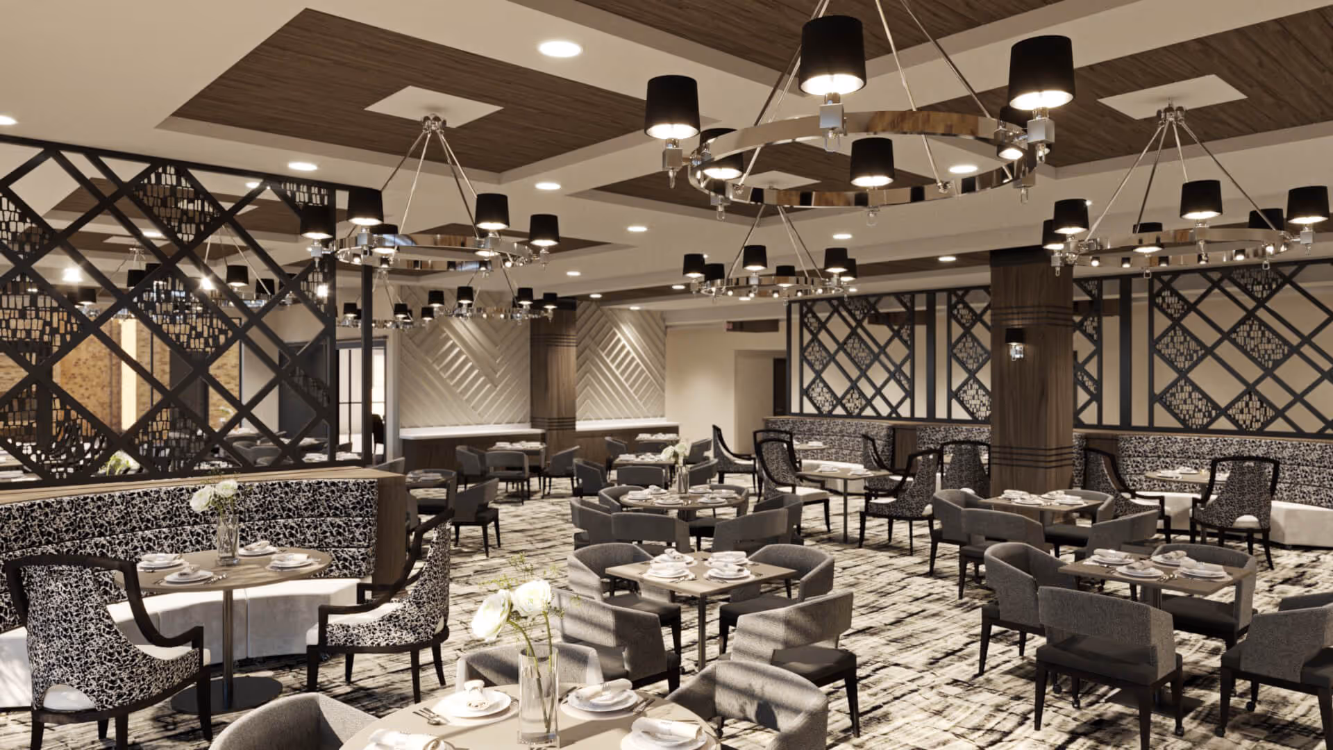 Spacious elegant dining room with multiple set tables, patterned chairs, chandeliers, and decorative partition walls.