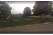 Exterior view of Oakview Nursing Home across a grassy lawn and street.