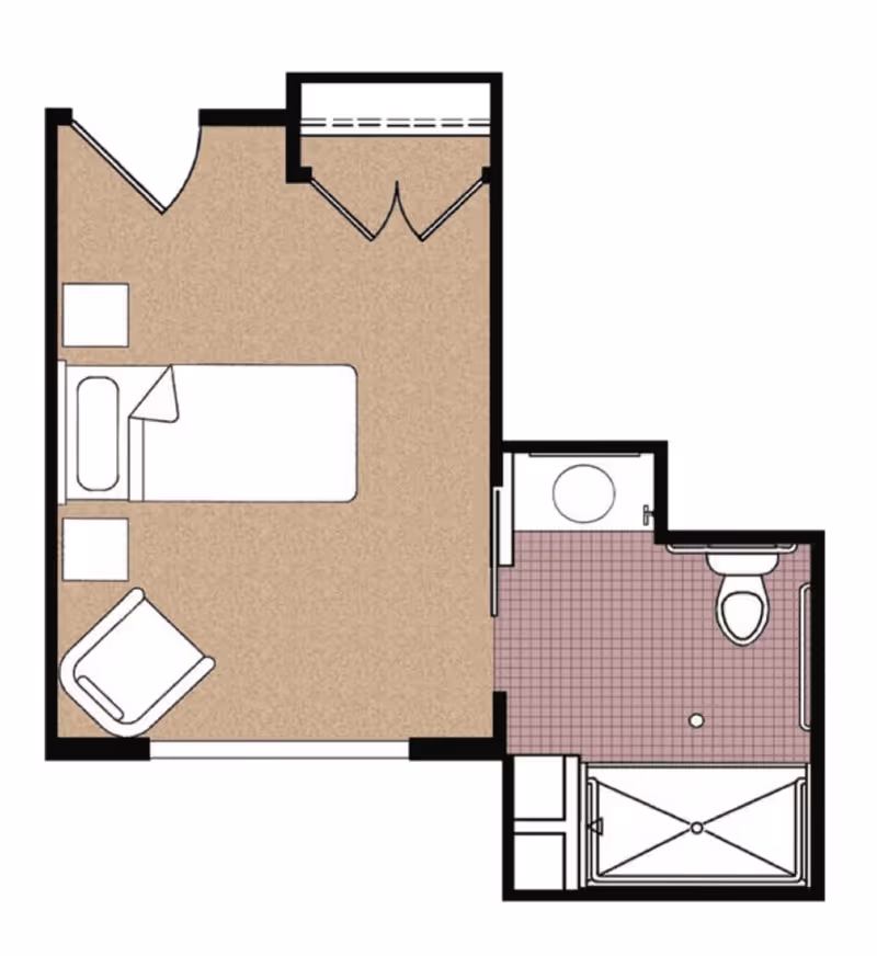 Floor plan of a memory care unit showing a bedroom area with a bed, two nightstands, a chair, and a closet. Adjacent to the bedroom is a bathroom with a sink, toilet, and shower.