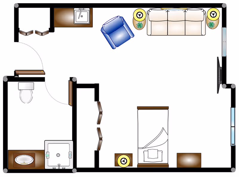 Floor plan of a senior living facility room showing a bedroom area with a bed, nightstand, and dresser, a living area with a sofa, armchair, two side tables with lamps and plants, a television mounted on the wall, and a bathroom with a toilet, sink, and shower.