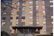 Oceanview Nursing Home exterior: brick building with glass entrance and stairs.