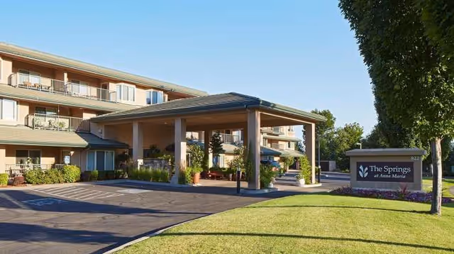 Exterior view of The Springs at Anna Maria with covered entrance and landscaped grounds.