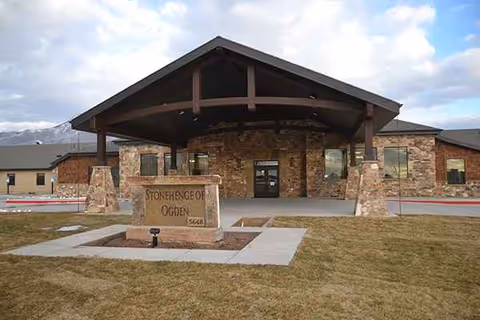 Stonehenge of Ogden exterior featuring a large covered entrance and stone facade.