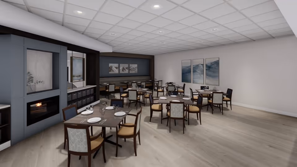 A spacious dining room with multiple set tables and chairs, a fireplace, and wall art.