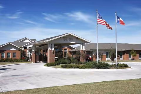 Front view of Pegasus Landing of Forney entrance with flags and landscaping