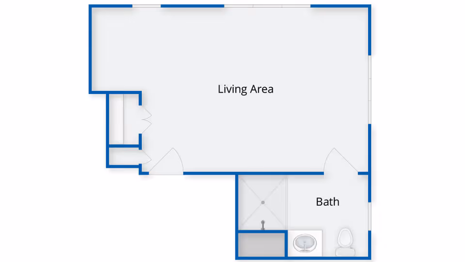 Floor plan layout showing a living area and a bathroom with a shower, sink, and toilet.