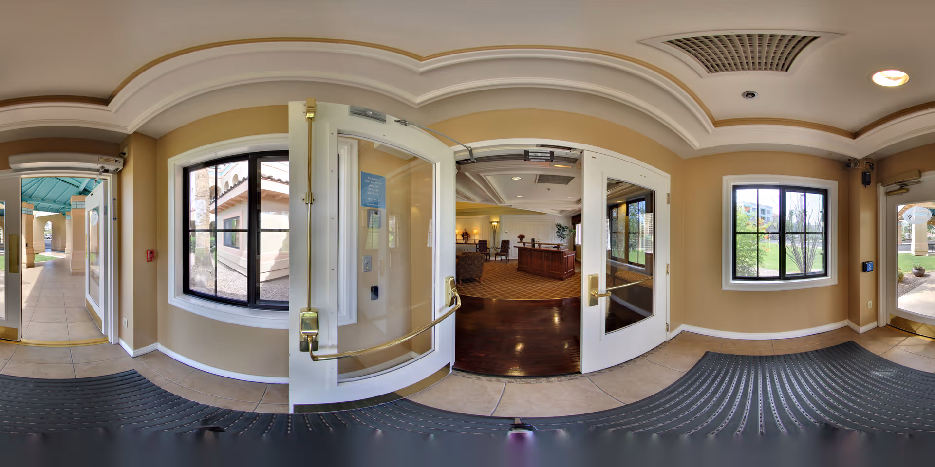 A panoramic view of the entrance area with open doors leading to a reception area.