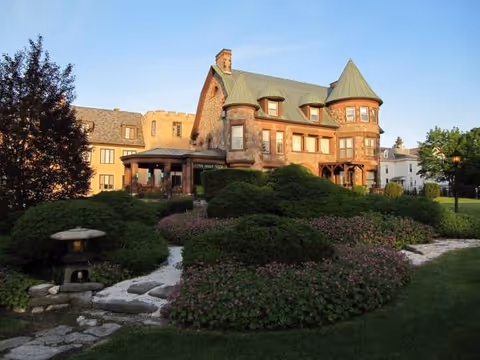 Arkell Hall exterior with turreted roof and manicured gardens.