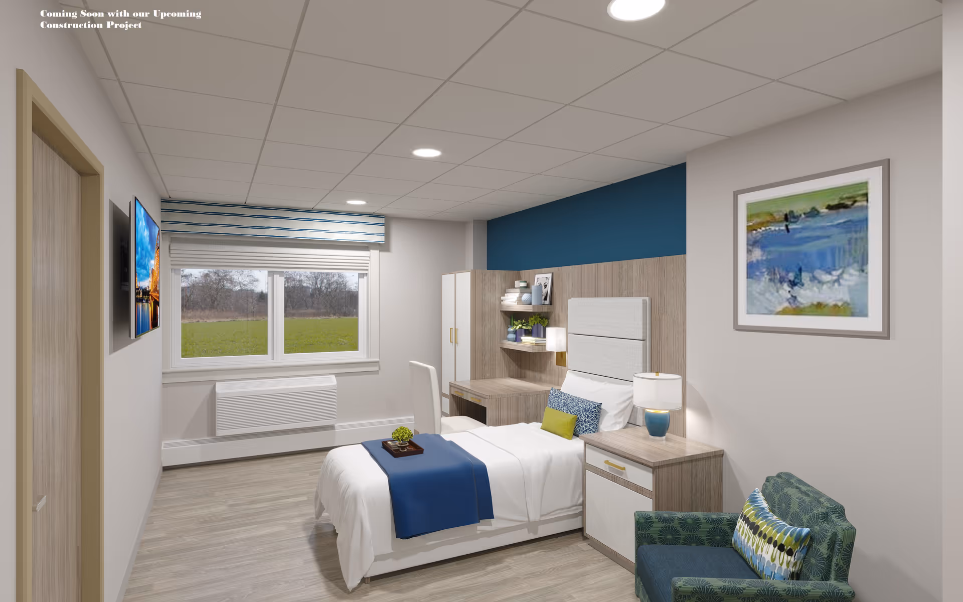 A modern, well-lit bedroom in an assisted living facility featuring a single bed with white and blue bedding, a wooden nightstand with a lamp, a green patterned armchair with a decorative pillow, a desk with shelves holding books and plants, a large window with a view of greenery outside, and a framed abstract painting on the wall.