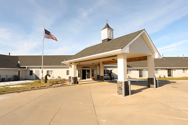 Exterior view of Kinship Pointe at Wayne showing the entrance and flag.